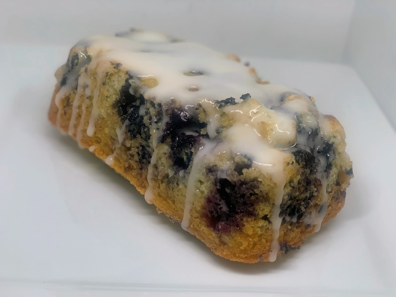 Blueberry bread loaf drizzled with lemon glaze