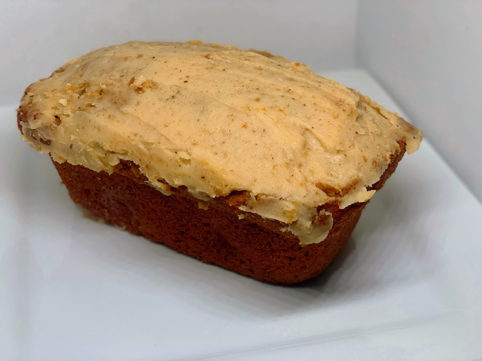 Golden bread loaf with thick caramel frosting